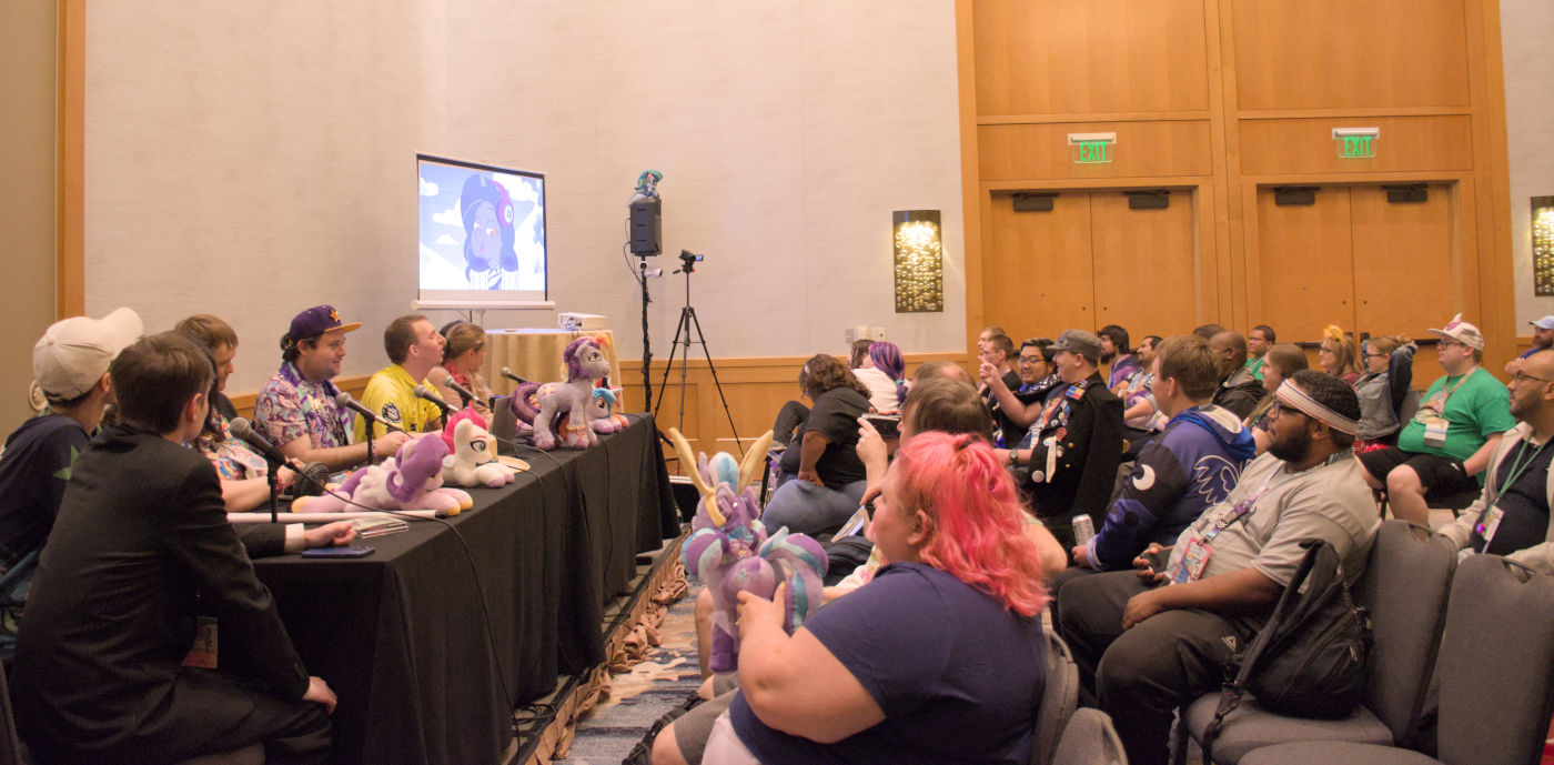 Community members presenting a panel to an audience.